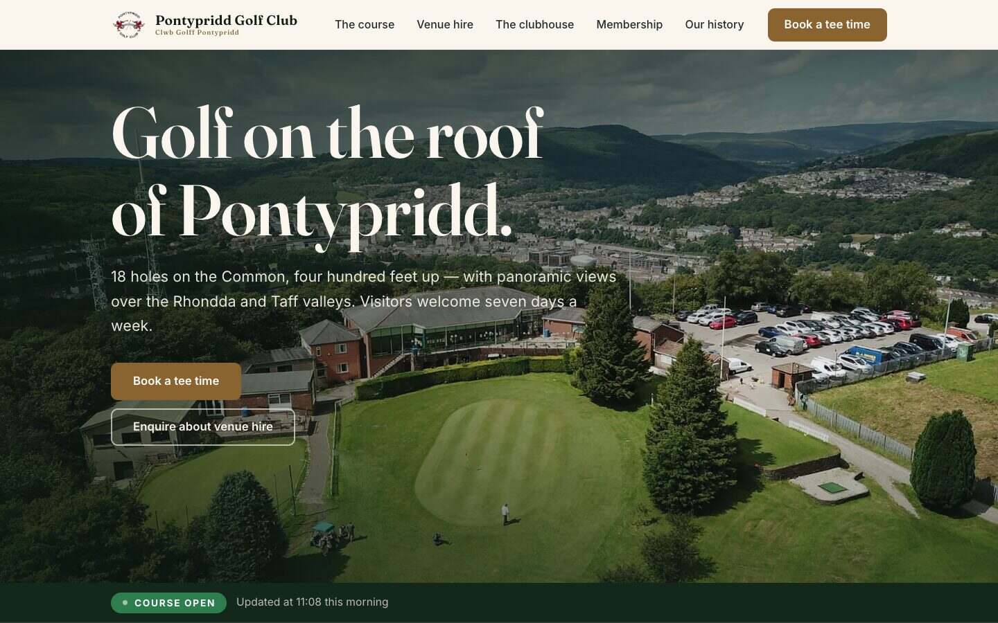 The Pontypridd Golf Club homepage hero: the clubhouse and putting green on the Common, the town four hundred feet below, the headline 'Golf on the roof of Pontypridd.' and the COURSE OPEN status strip beneath it.